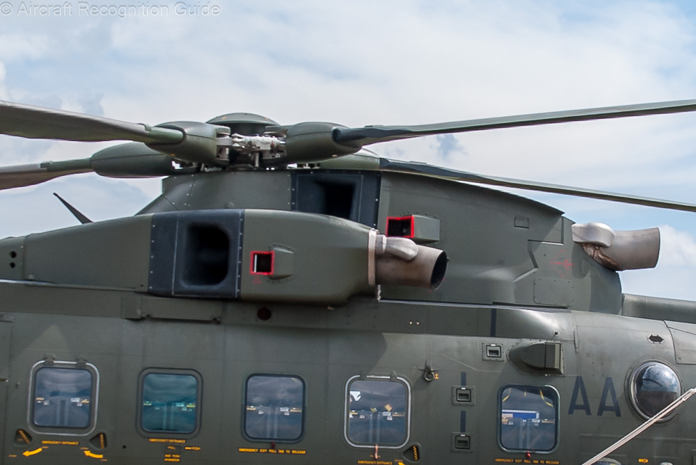 The left and right engine of the EH101/AW101 are in separate nacelles at the side of the gear box pylon, and having outward facing exhausts. Image