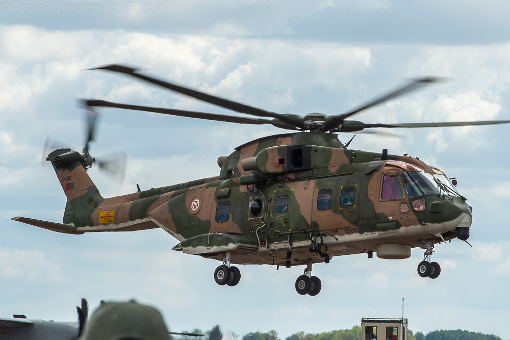This AW101 Mk514 of Portugal has no folding tail boom and covered RWR sensors on the nose, typical for this specific variant. Also note the small radar disk under the forward fuselage and the cabin window configuration. Image