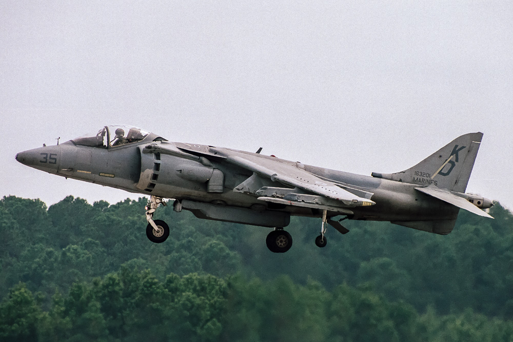 A US Marine Corps AV-8B in hover. Note the 'clean' blunt nose and single row of doors on the air intake. Also, the traversal flap behind the nose gear is extended. Image